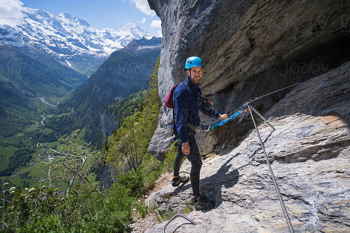 Smiling Explorer Climbing Via Ferrata
