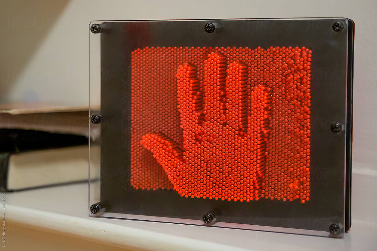 Orange pegboard with high five hand