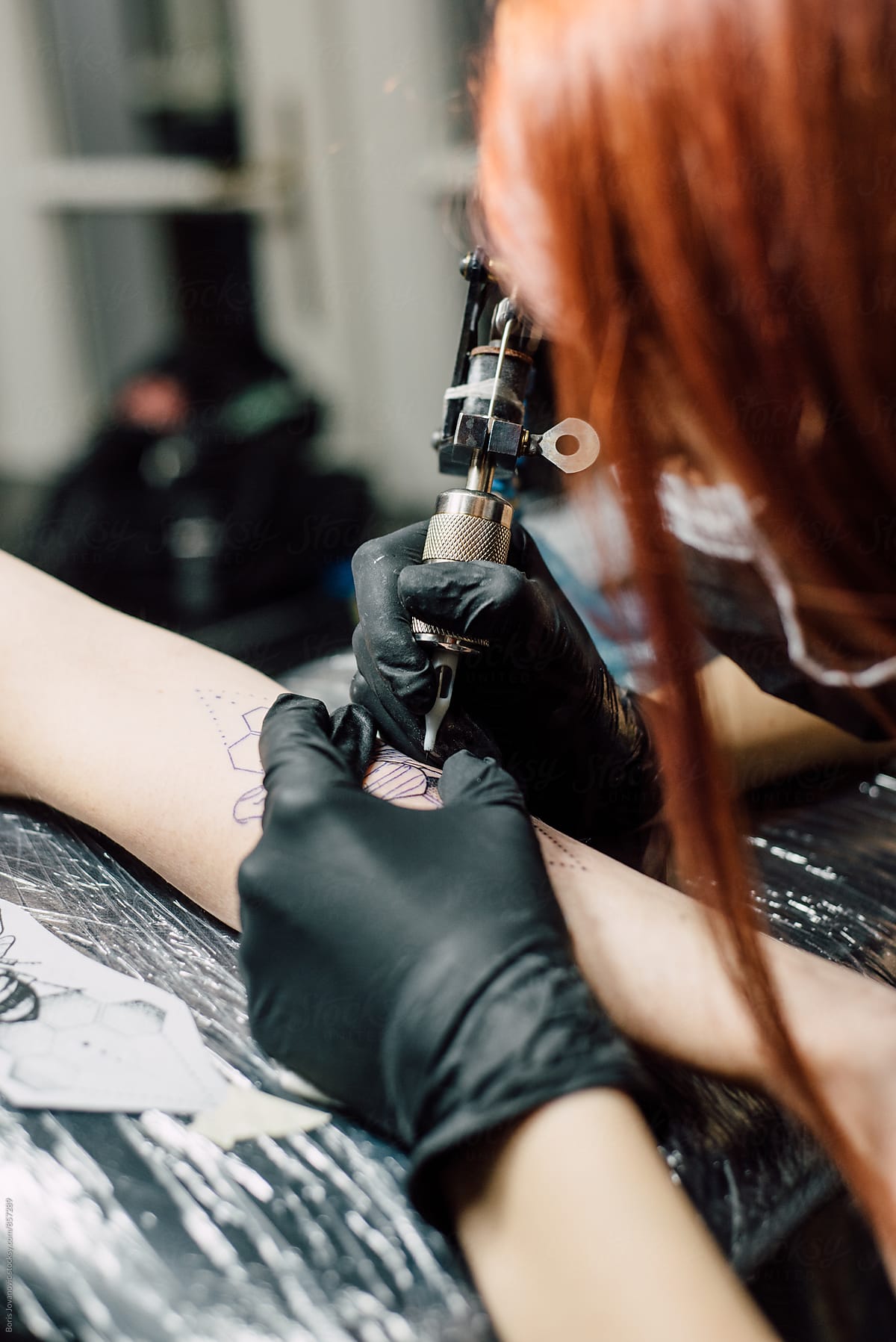 Tattoo artists doing a tattoo