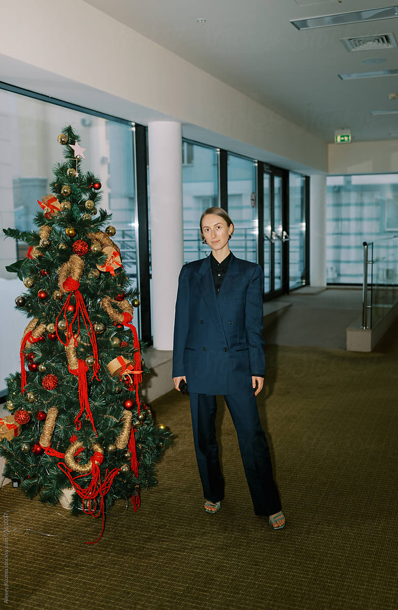 Business woman wearing man classic suite  and christmas tree