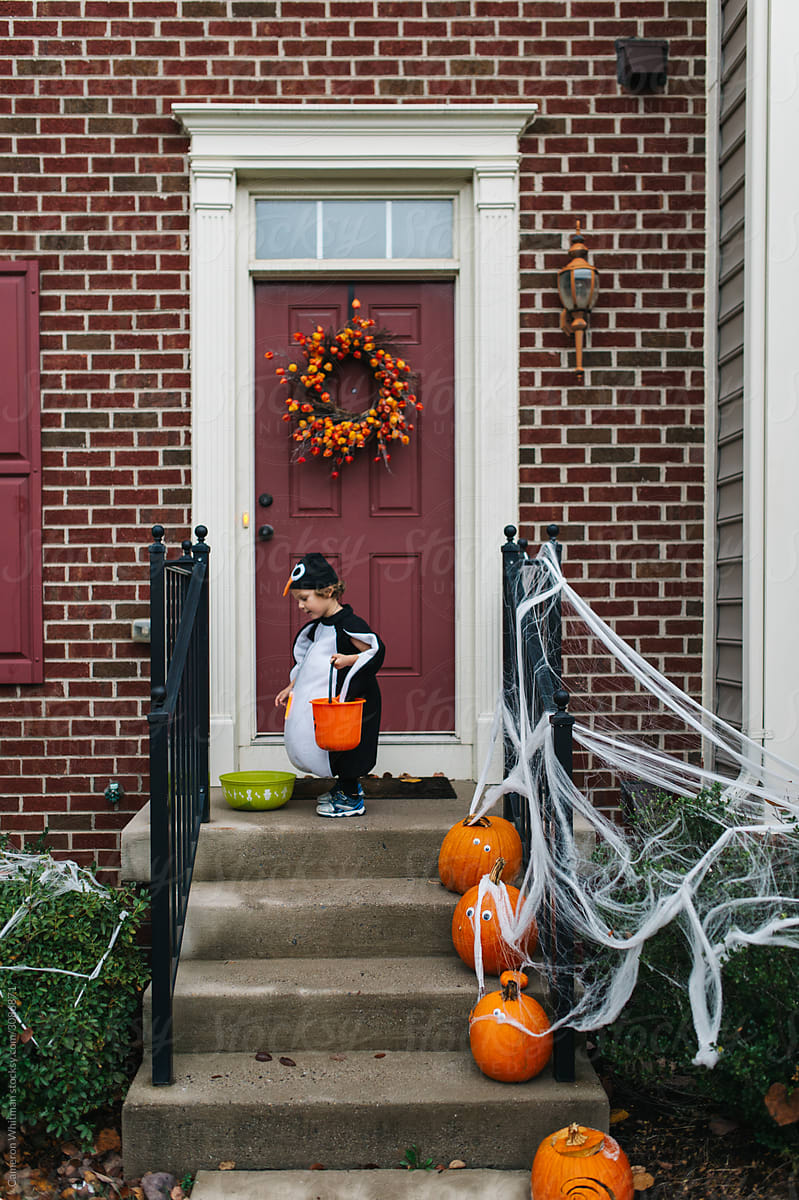 Trick or treater reaches into a candy bucket