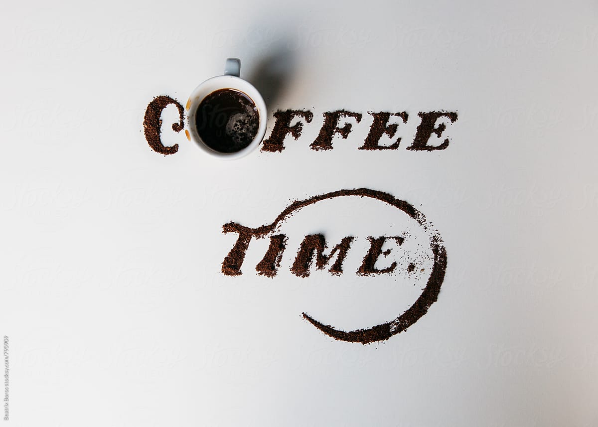 Coffee time written with grounded coffee on white background