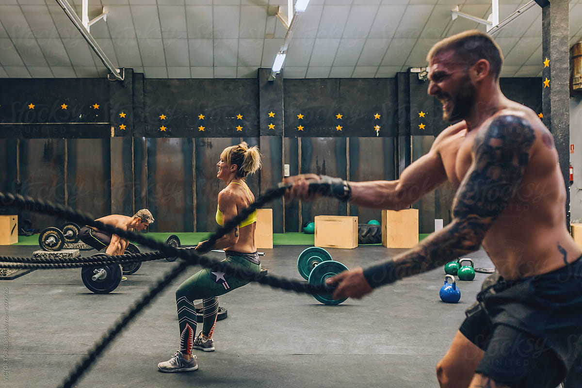 People exercising with battle ropes