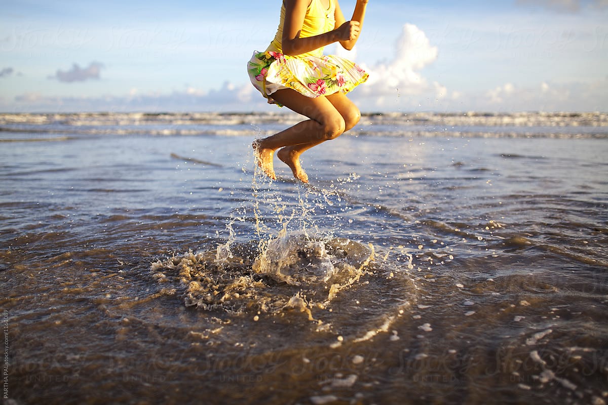 Teenage Girl Jumping And Making Fun In A Sea Beach Del Colaborador De Stocksy Dream Lover