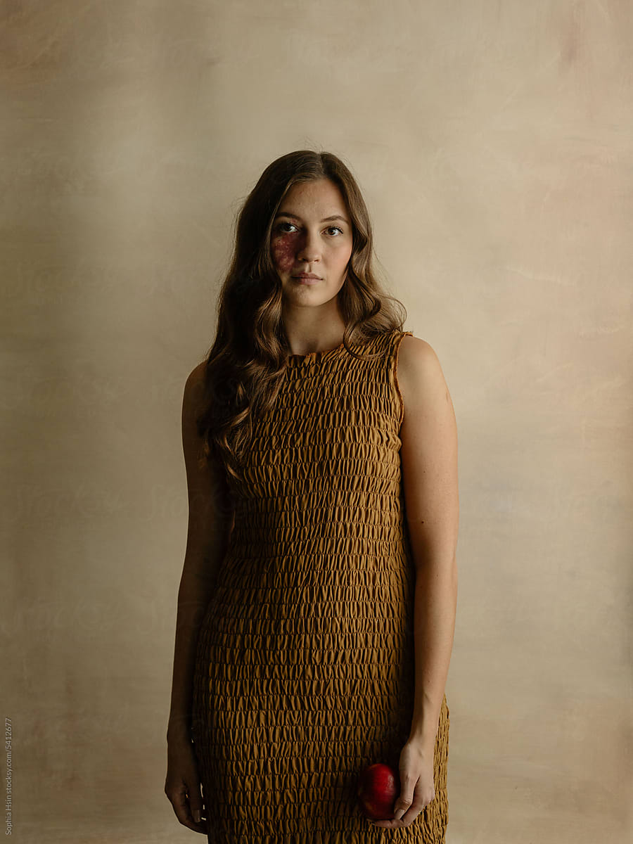 Portrait of a young woman with beige background