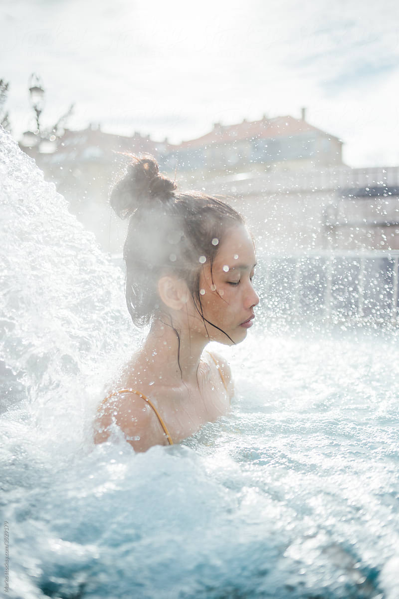 Young beautiful asian woman enjoying outdoor hot bath in spa