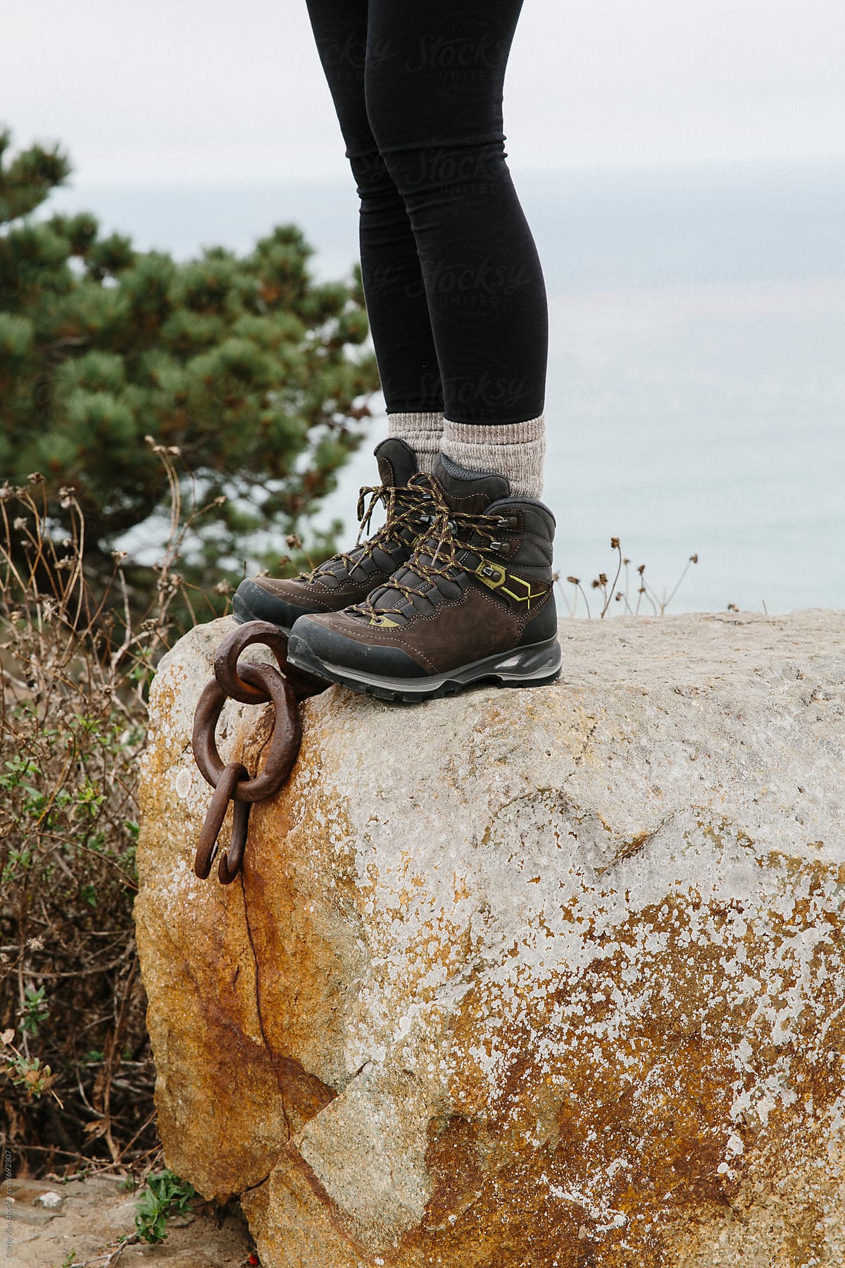 Woman\'s hiking boots on rock