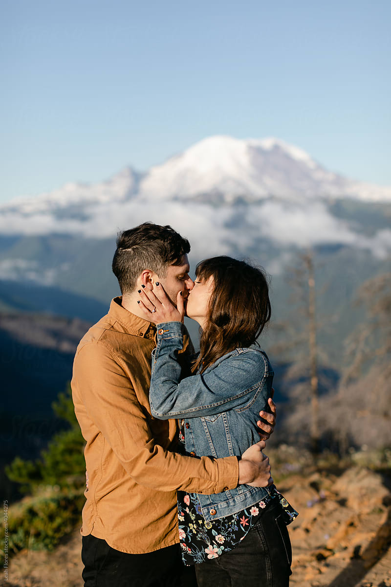 Couple Kissing with Mountain in Background