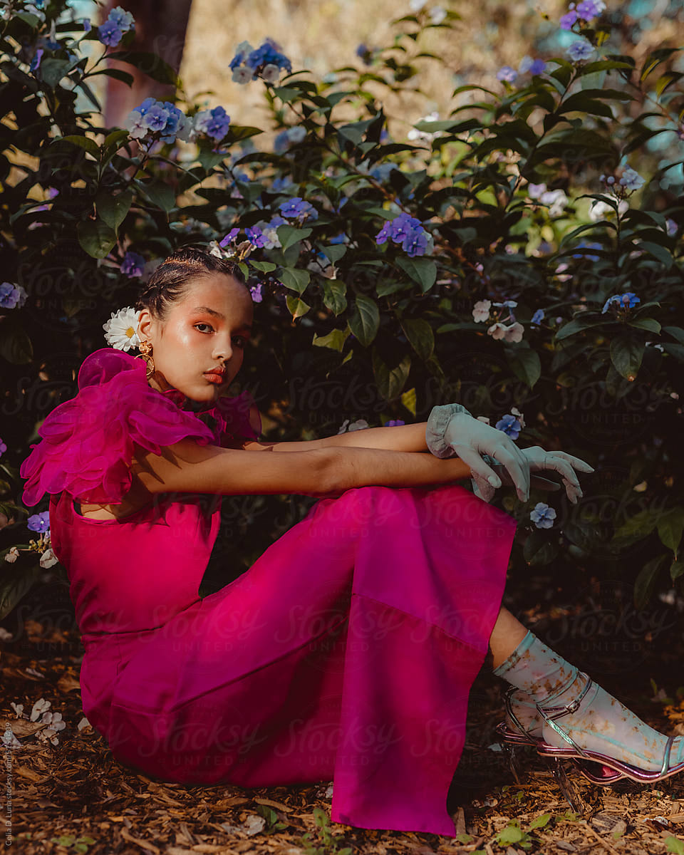 Young afro latinx woman sitting in a garden