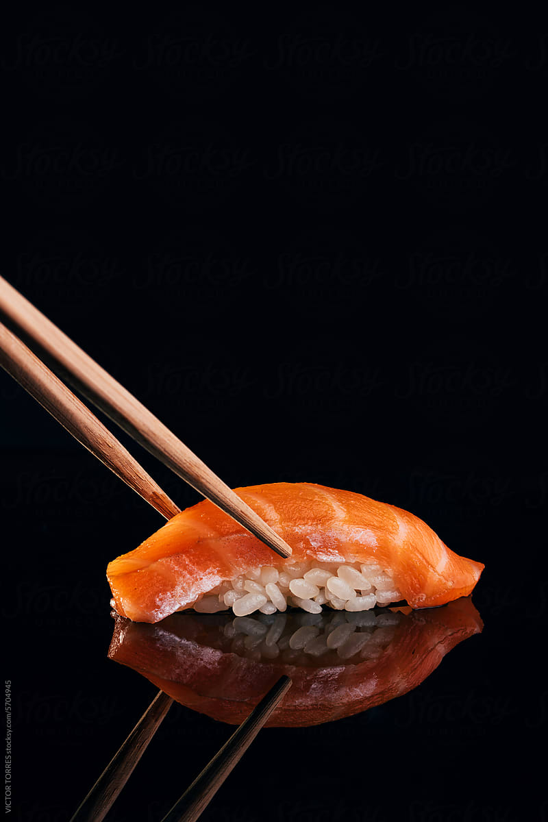 Chop sticks picking salmon nigiri sushi