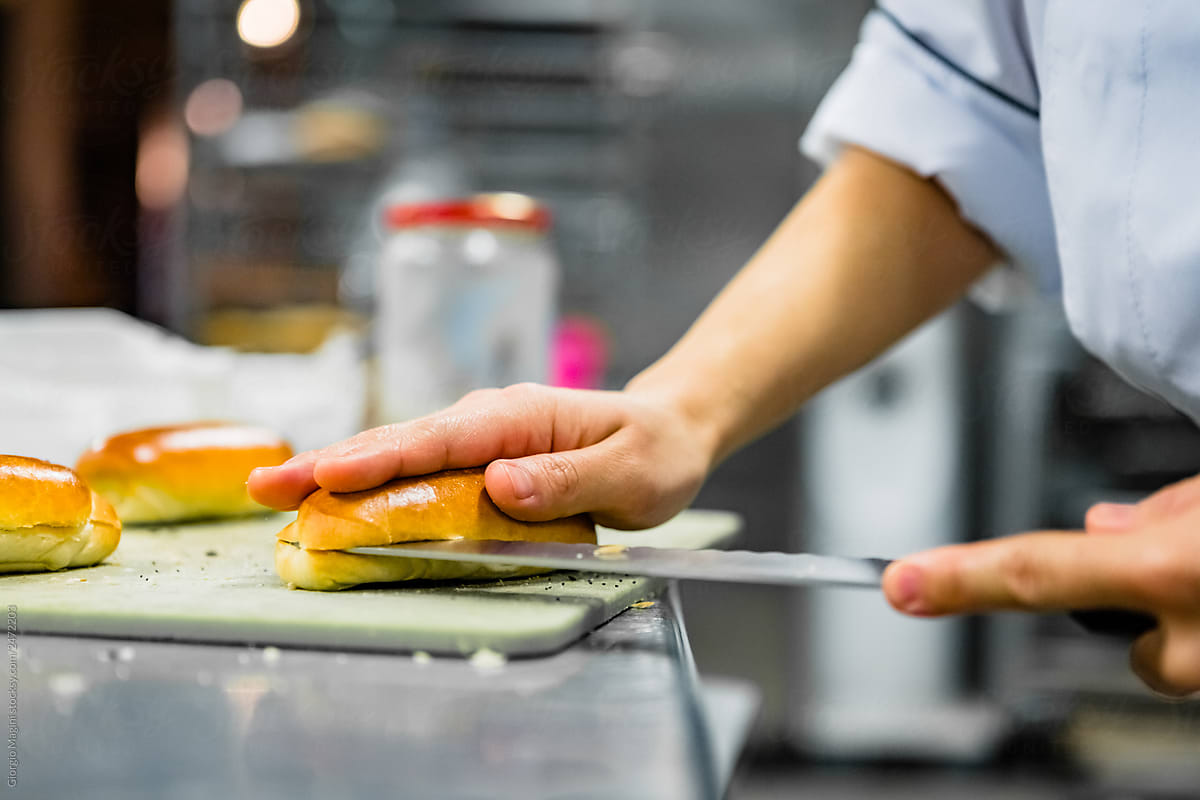 Chef Cutting Panini Sandwich in Professional Kitchen