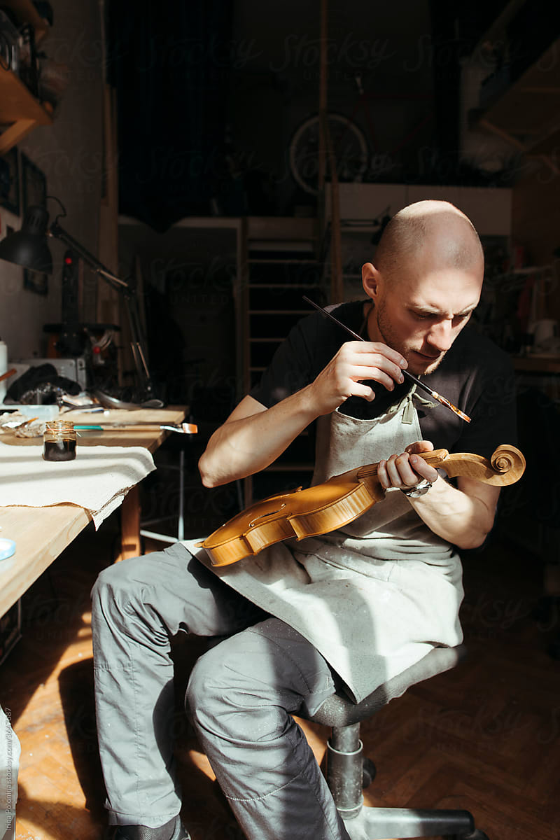 A violin artisan in his workshop.
