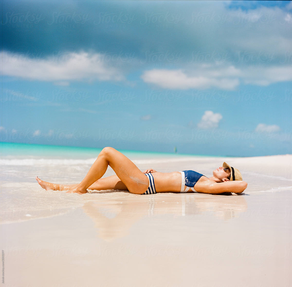 Beautiful Woman In A Bikini Laying On A Beach Stocksy United