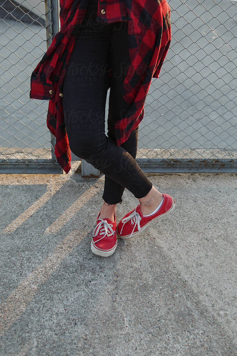 Faceless woman in red sneakers