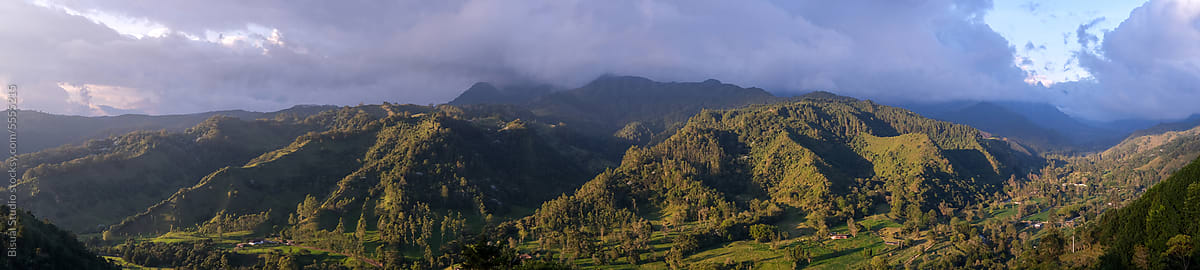 Picturesque view of green valley surrounded with mountains in daylight