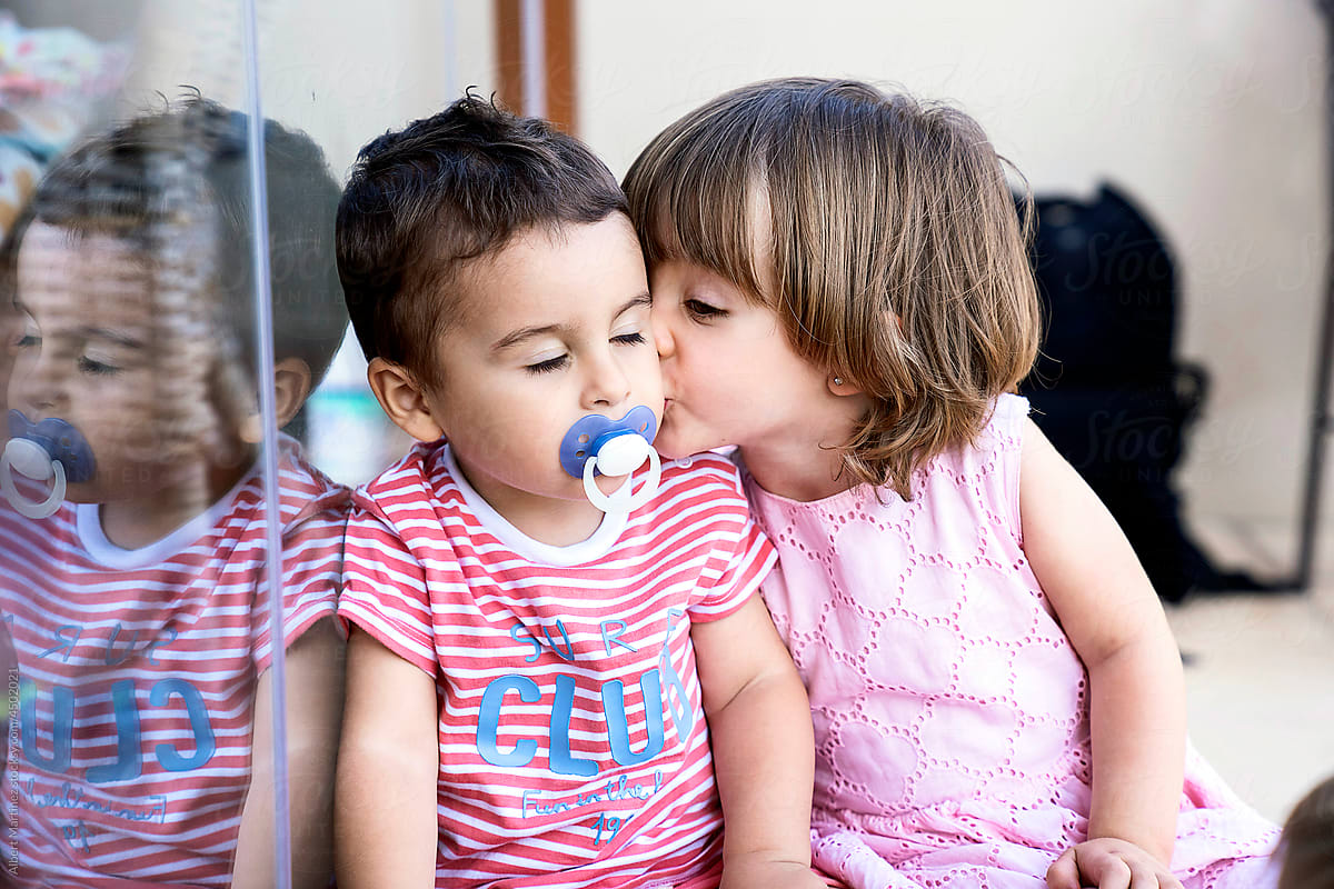 Little girl kissing cute brother