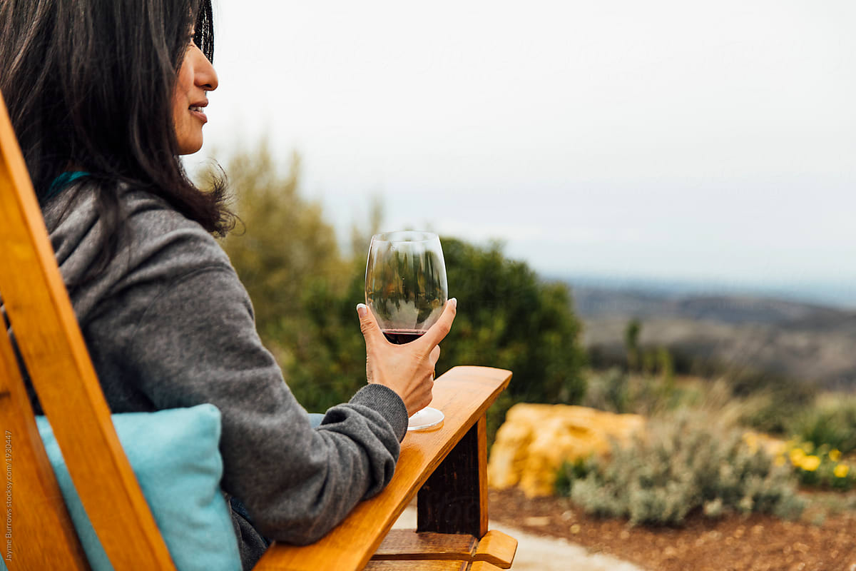 Japanese Woman Sits With Wine Glass in Hand.