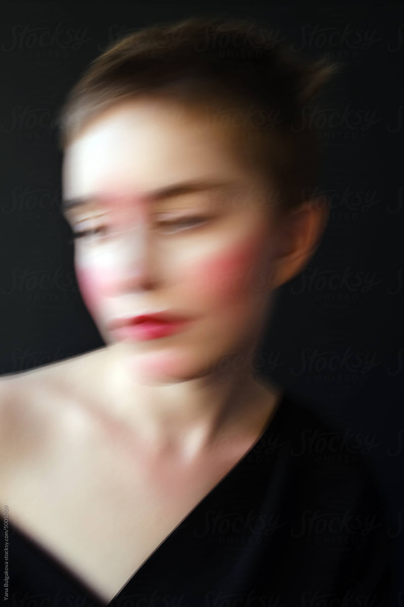 Blurred portrait of young woman in studio