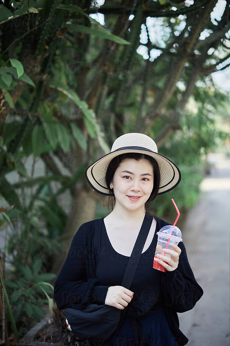 Happy Asian Woman Holds A Cup Of Fresh Watermelon Juice.