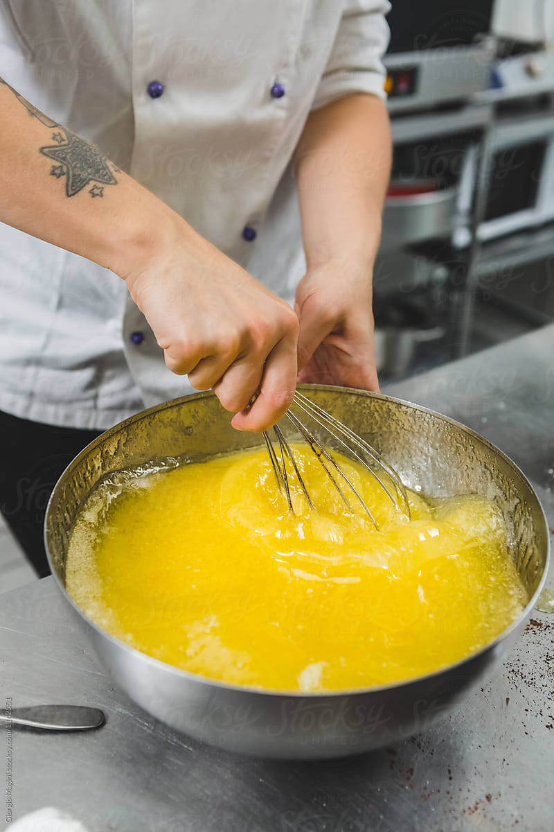 Pastry Chef Stirring Eggs Batter with a Wire Whisk