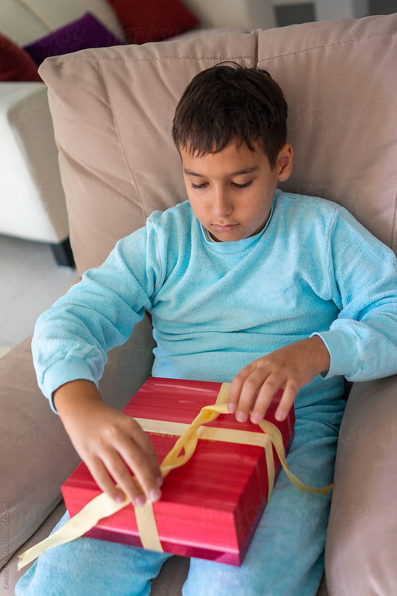 Boy in Pajama Wrapping a Gift