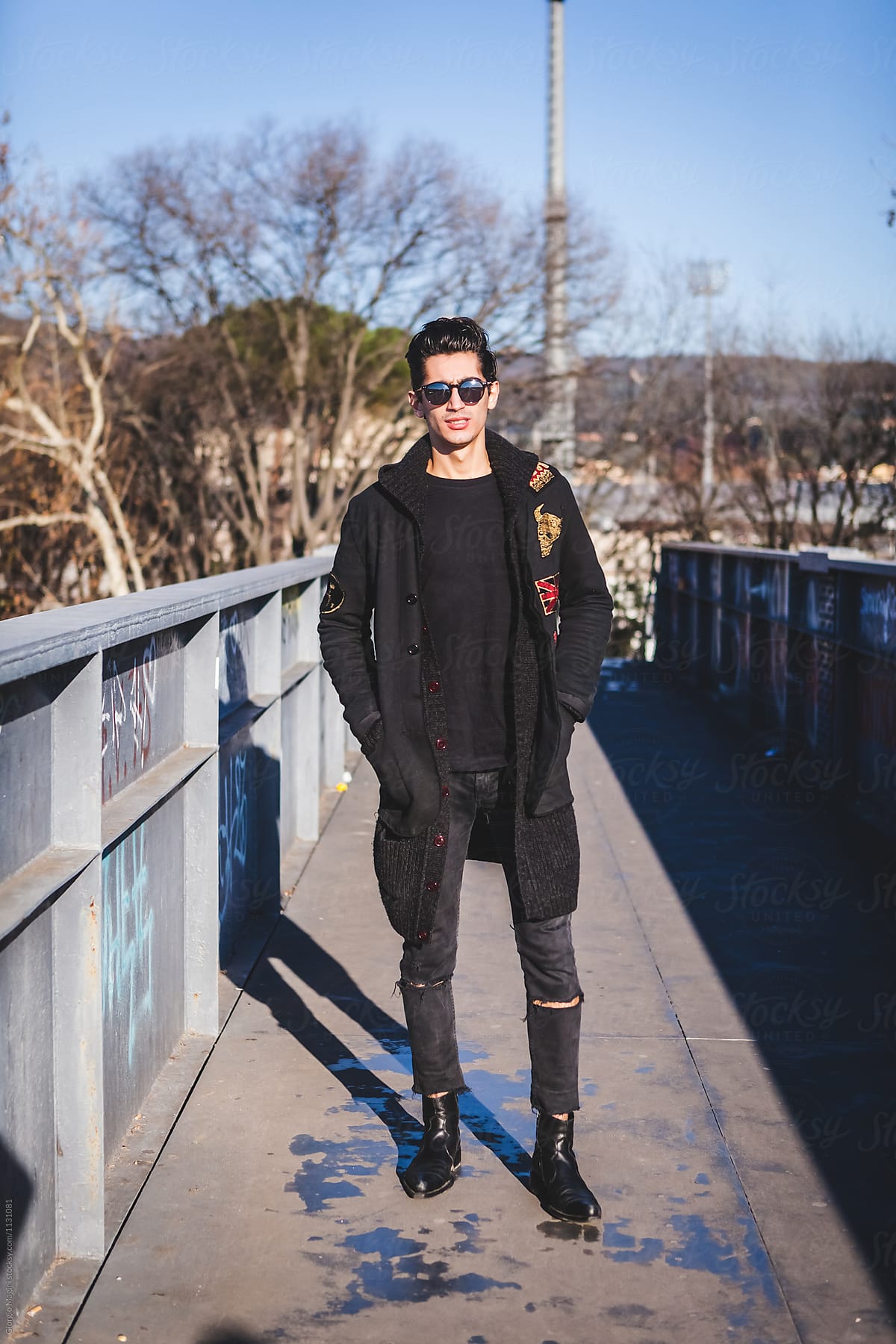 Young Man Dressed in Black Posing Tough in Urban Area