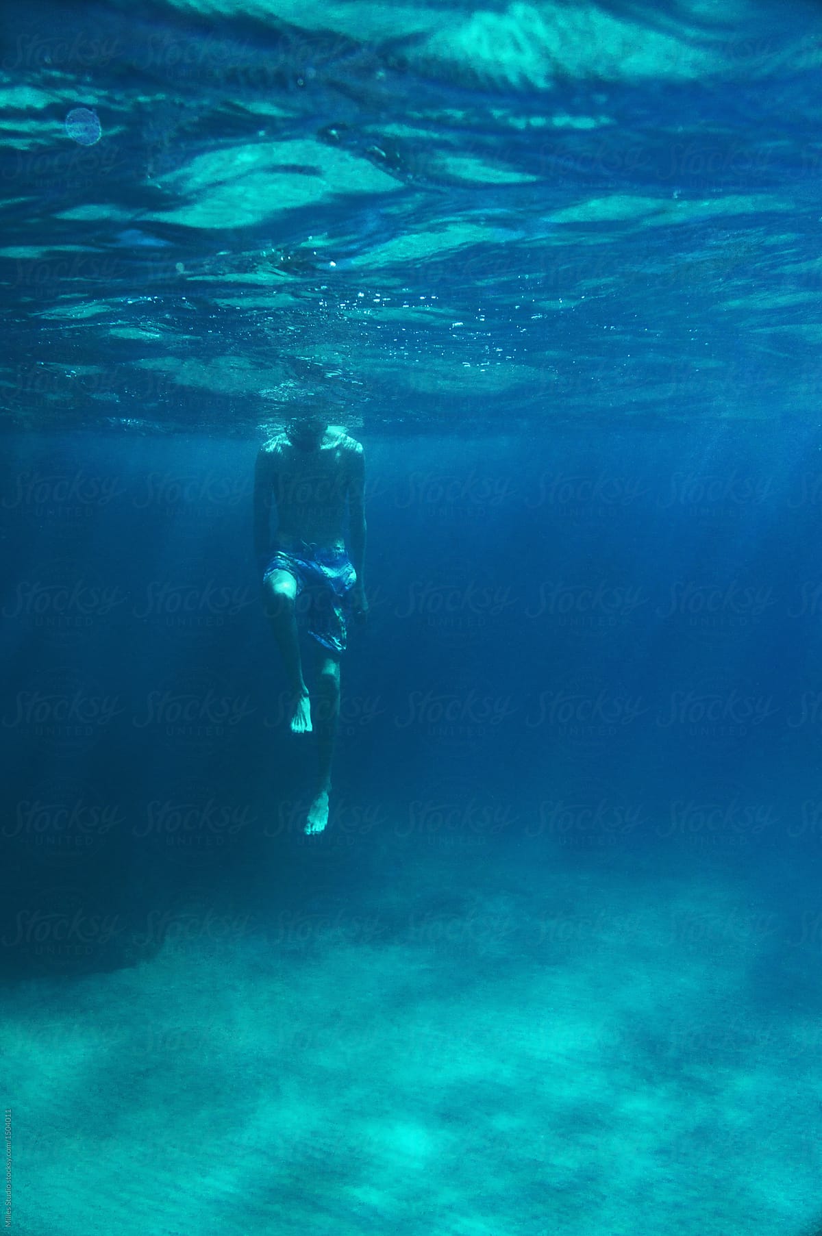 Man diving in blue water