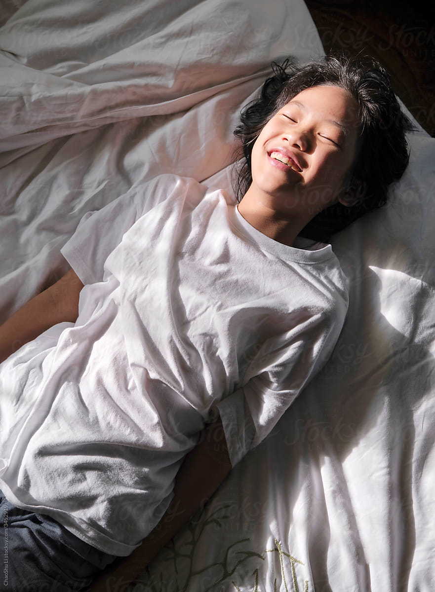 Beautiful Asian Girl On The Bed In The Morning Sunlight By Stocksy Contributor Chaoshu Li