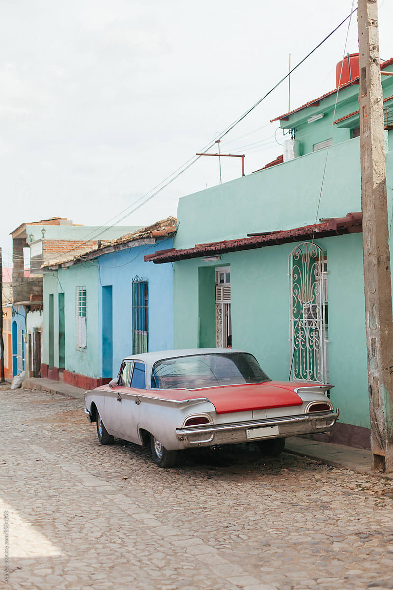 Old-timer car parked in front of colonial houses in Trinidad, Cu