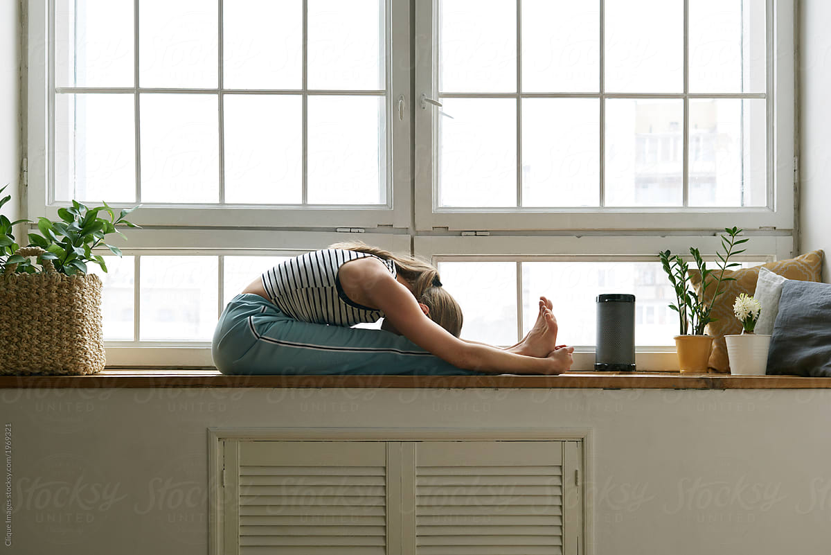 Woman stretching on window sill