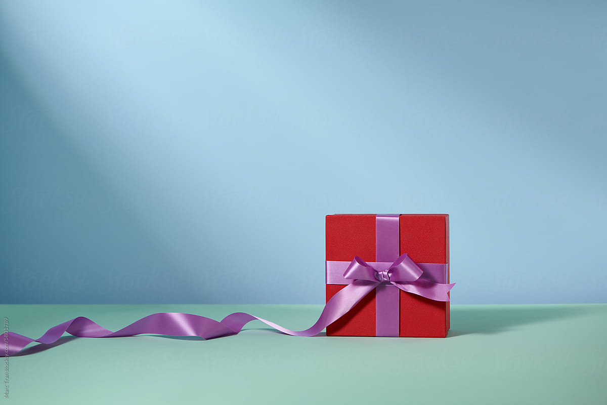 A red gift box on blue background