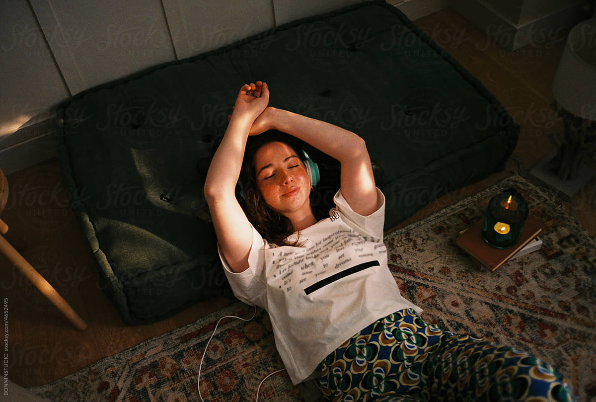 User-generated content teen resting on floor listening music