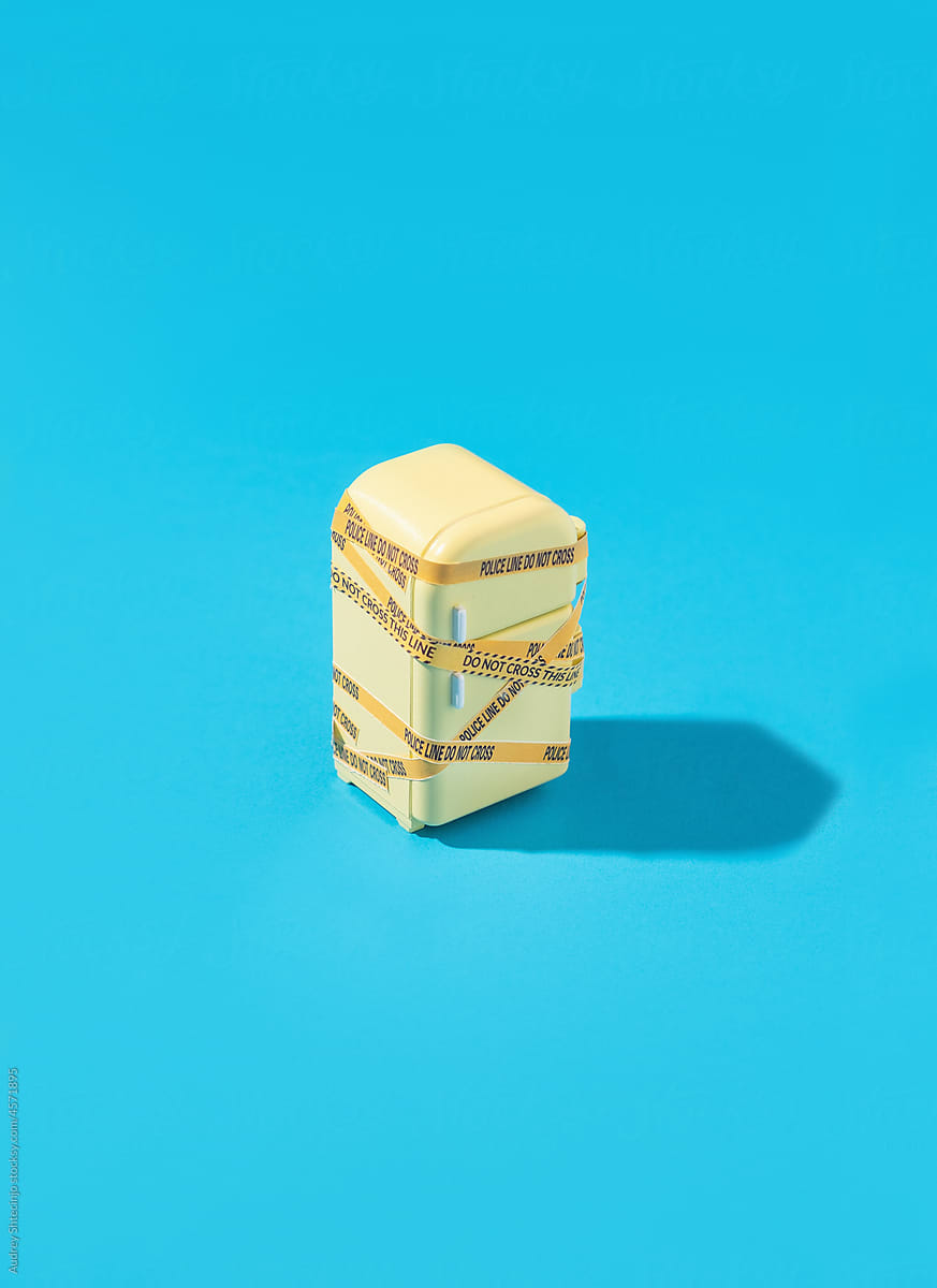 Miniature of taped refrigerator on blue background