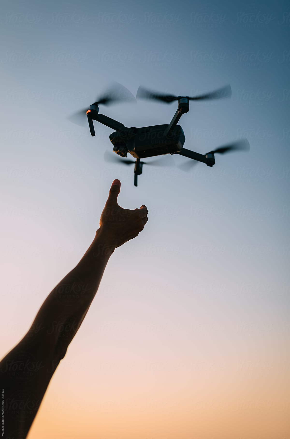 Closeup shot of man grabbing a drone in the air
