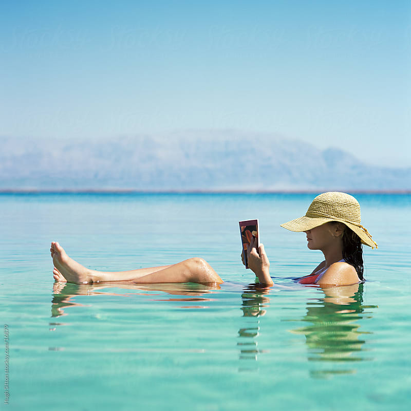 Woman floating on the Dead Sea. Israel by Hugh Sitton for Stocksy United