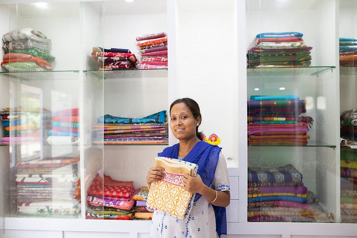 A Businesswoman who sells traditional Indian dress in a small shop