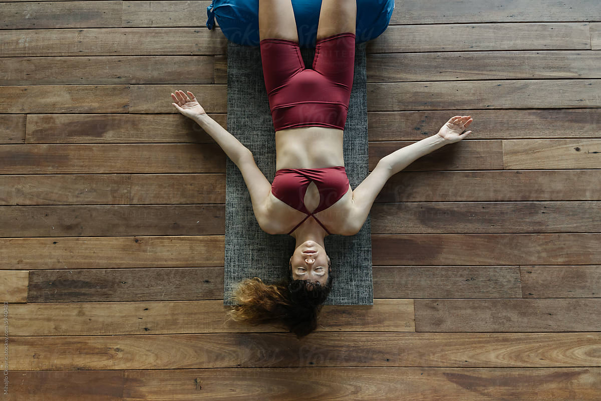 Overhead view of woman relaxing after yoga session