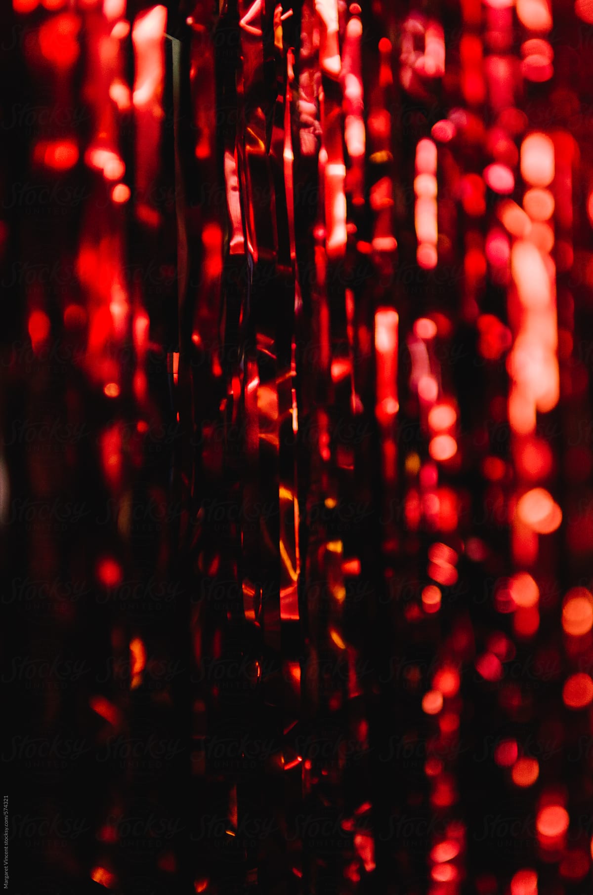 Shimmery Red Streamers, Vertical by Stocksy Contributor Margaret