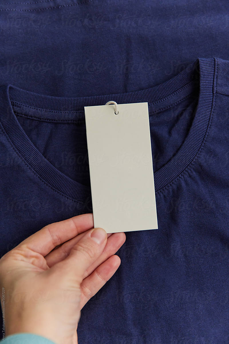Blank  clothing label attached to blue tshirt