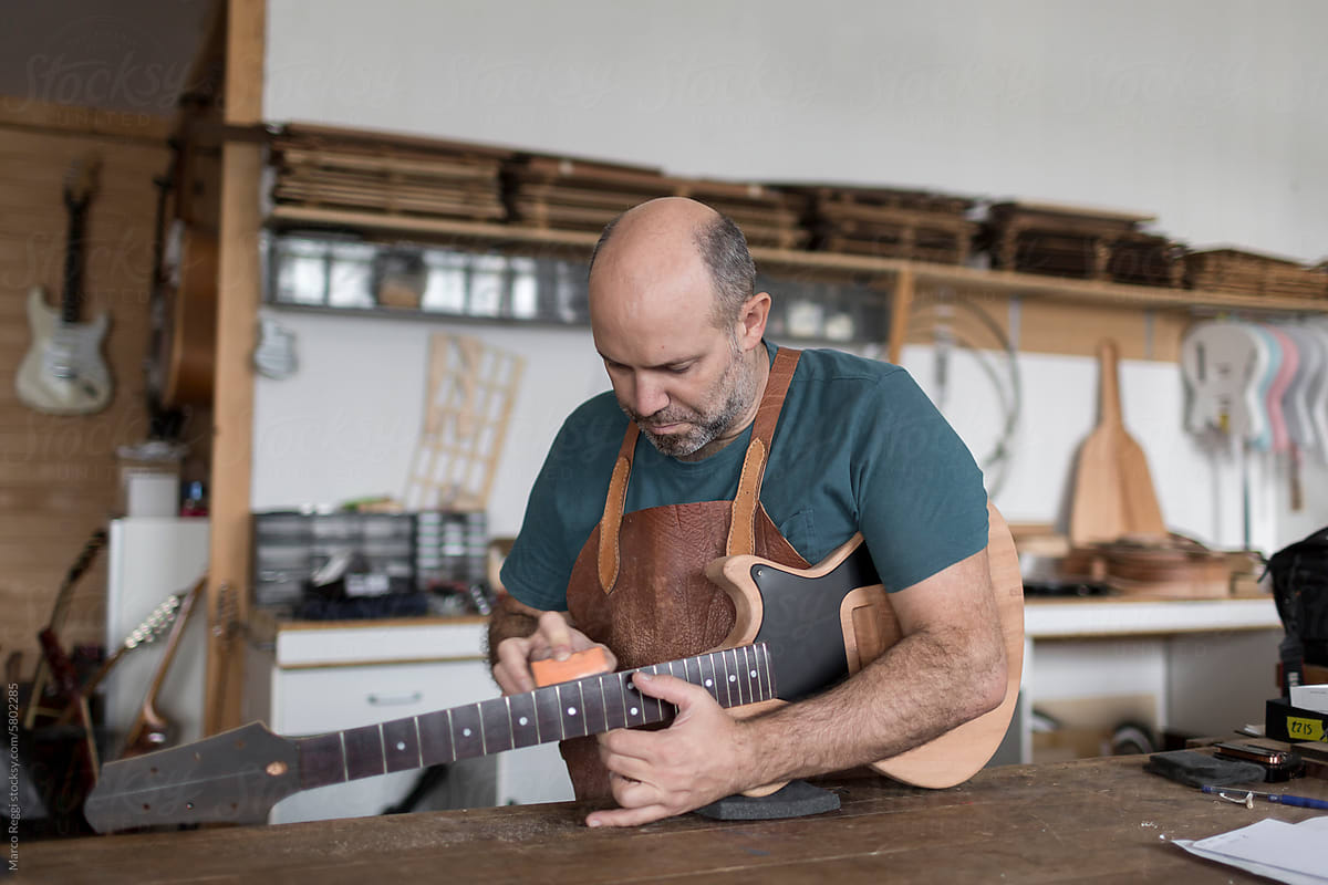 Luthier Repairing a guitar