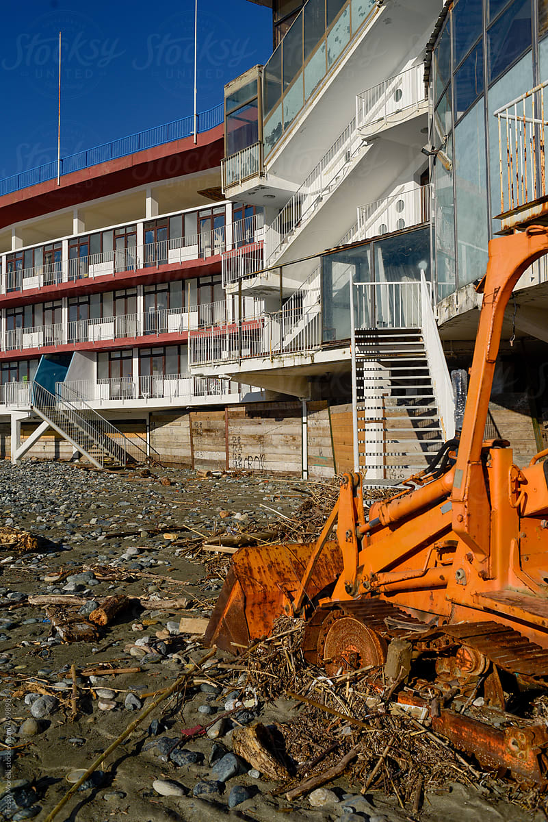 Polluted beach after the storm with bulldozer