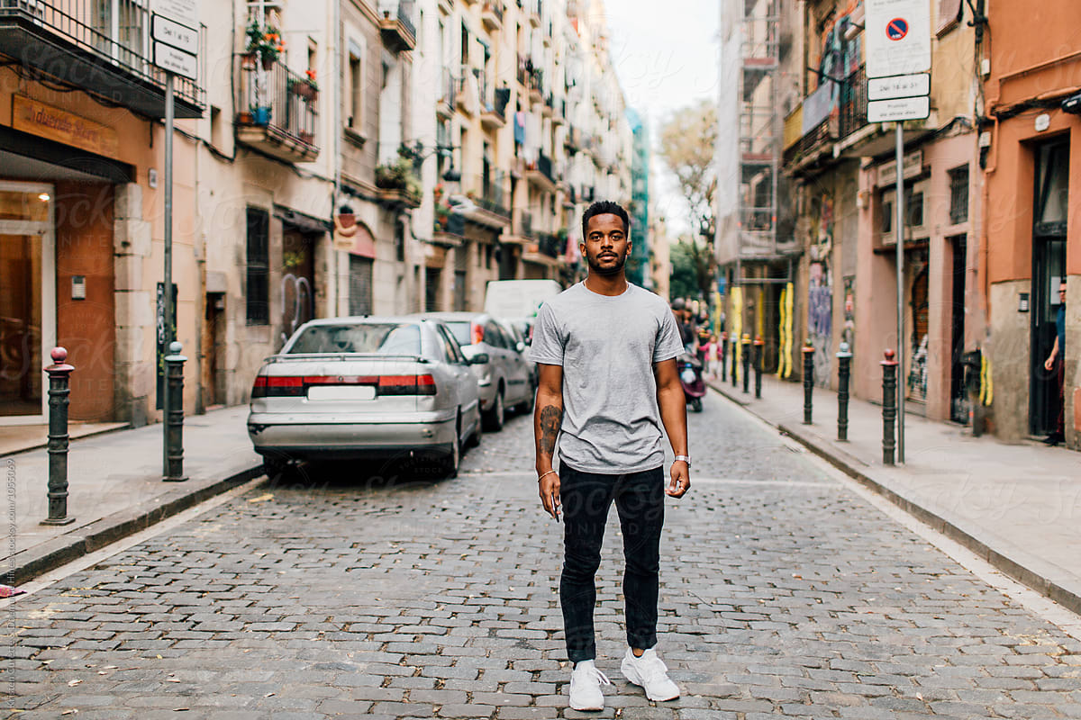 A man standing in the middle of the street in Barcelona, Spain