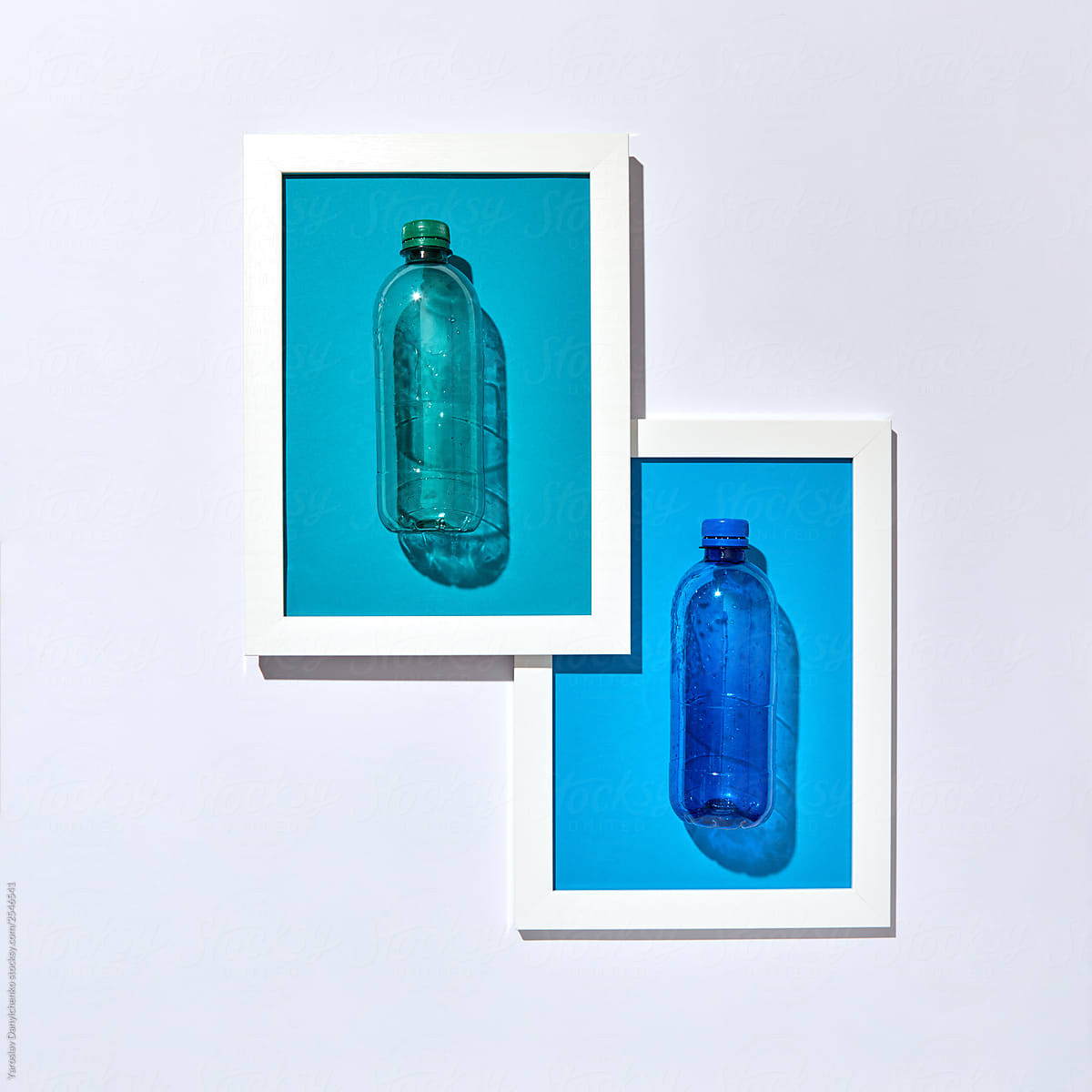 Two plastic bottles in a frame on a light background