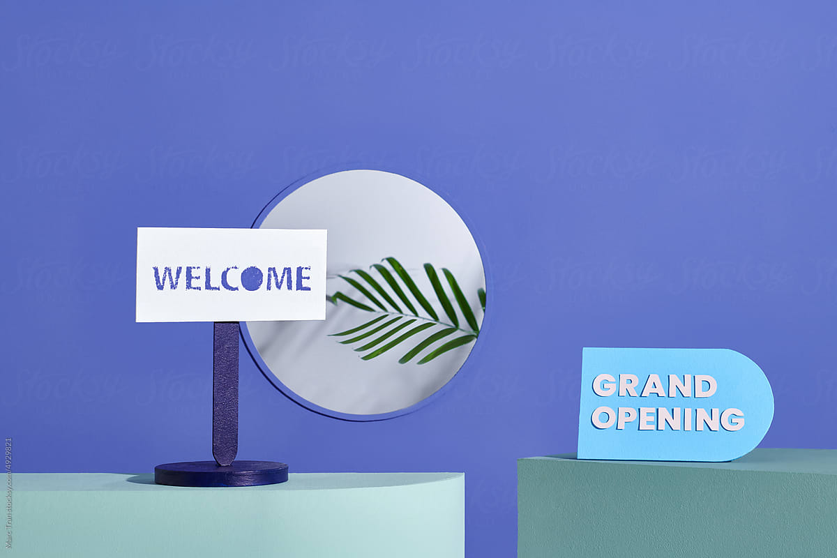 A blue sign with the words BRAND OPENING is standing to advertise