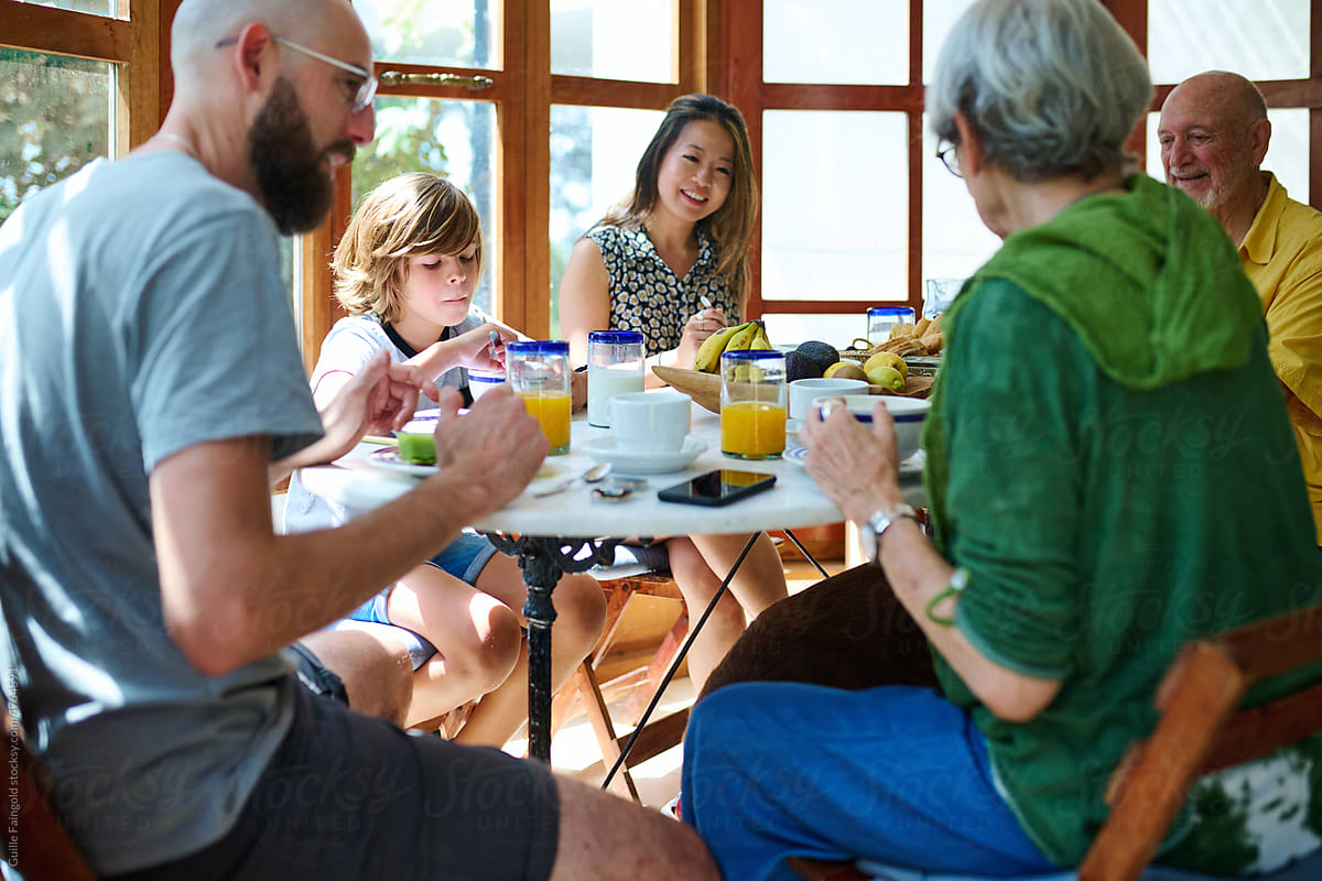 Diverse family at table enjoying breakfast
