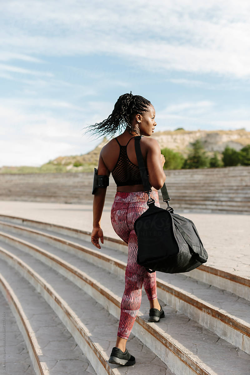 African American woman on sportswear with sport bag