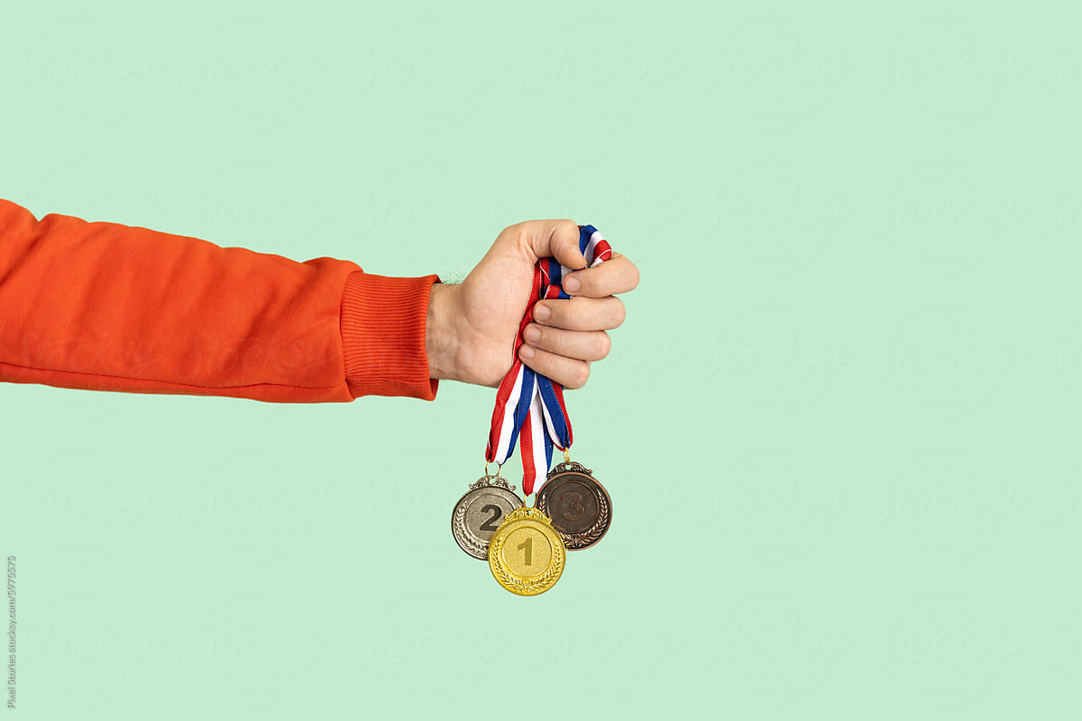 Person holding medals. Success, competition, winner, award.