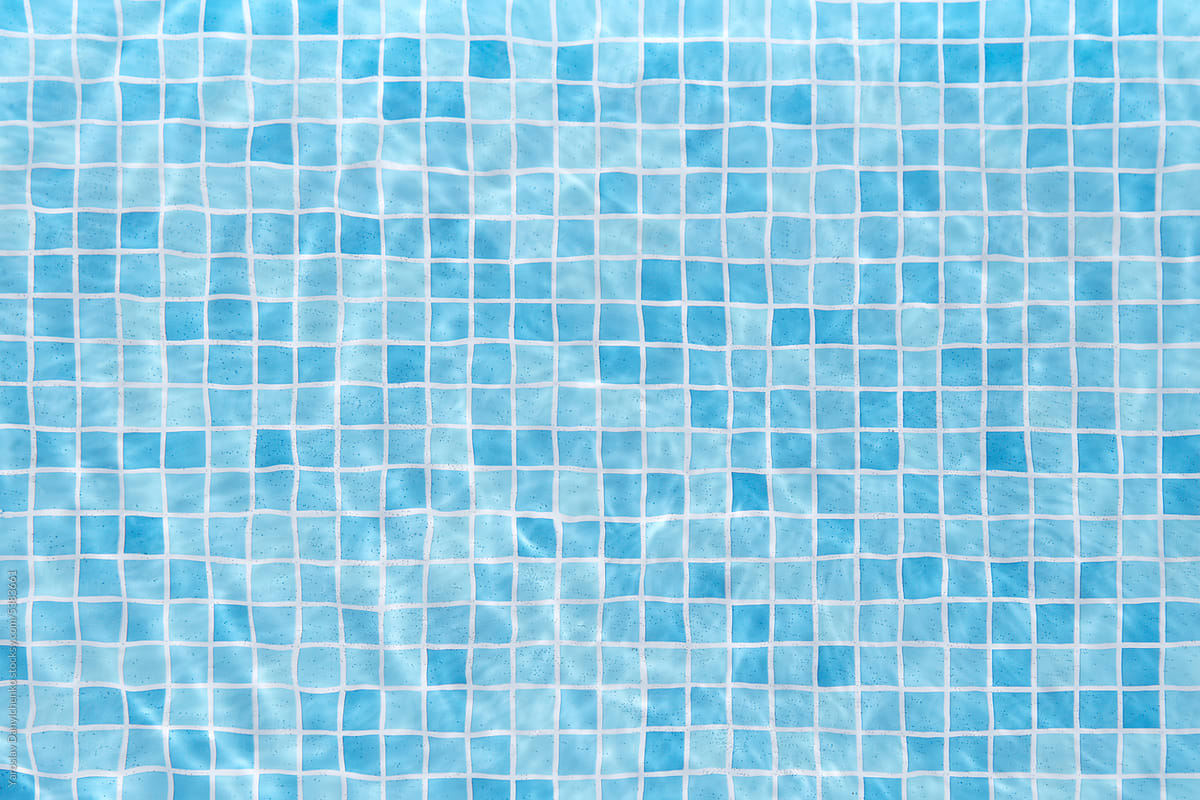 Swimming pool with water and blue tiles background.