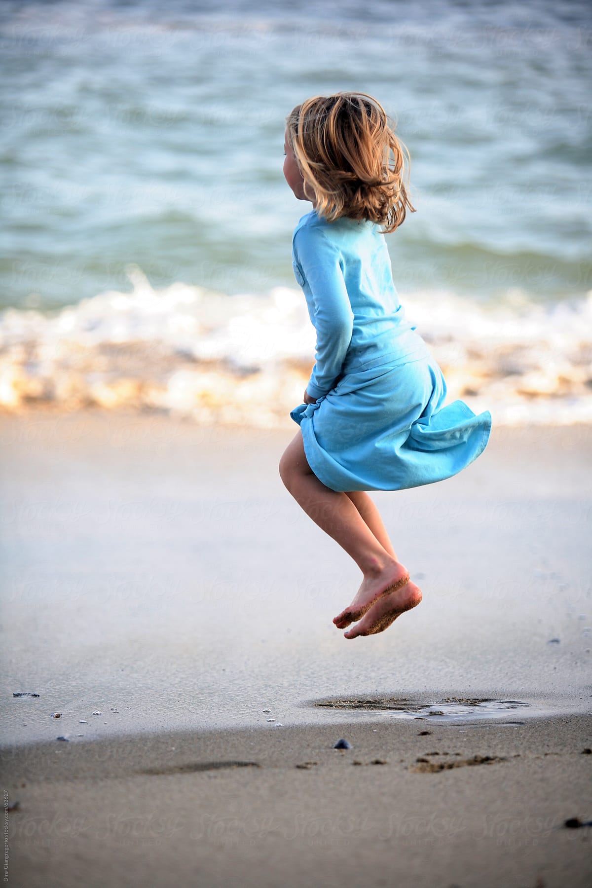 Little Girl Jumping on the Beach