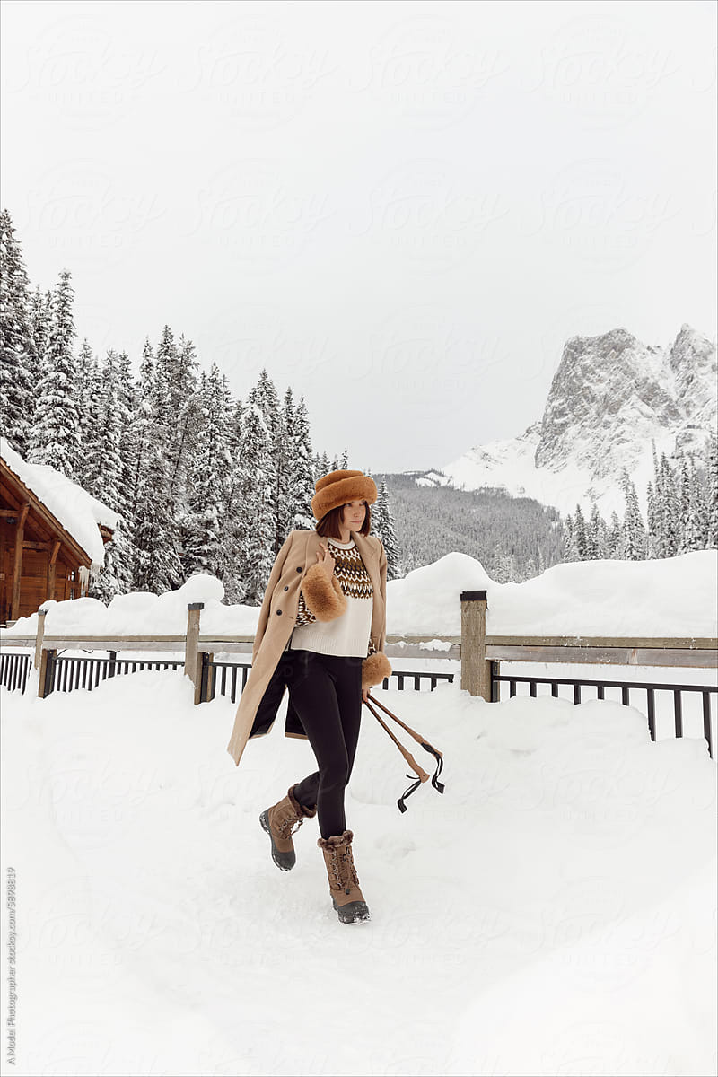 Winter photos of a woman in the snow with a beautiful landscape
